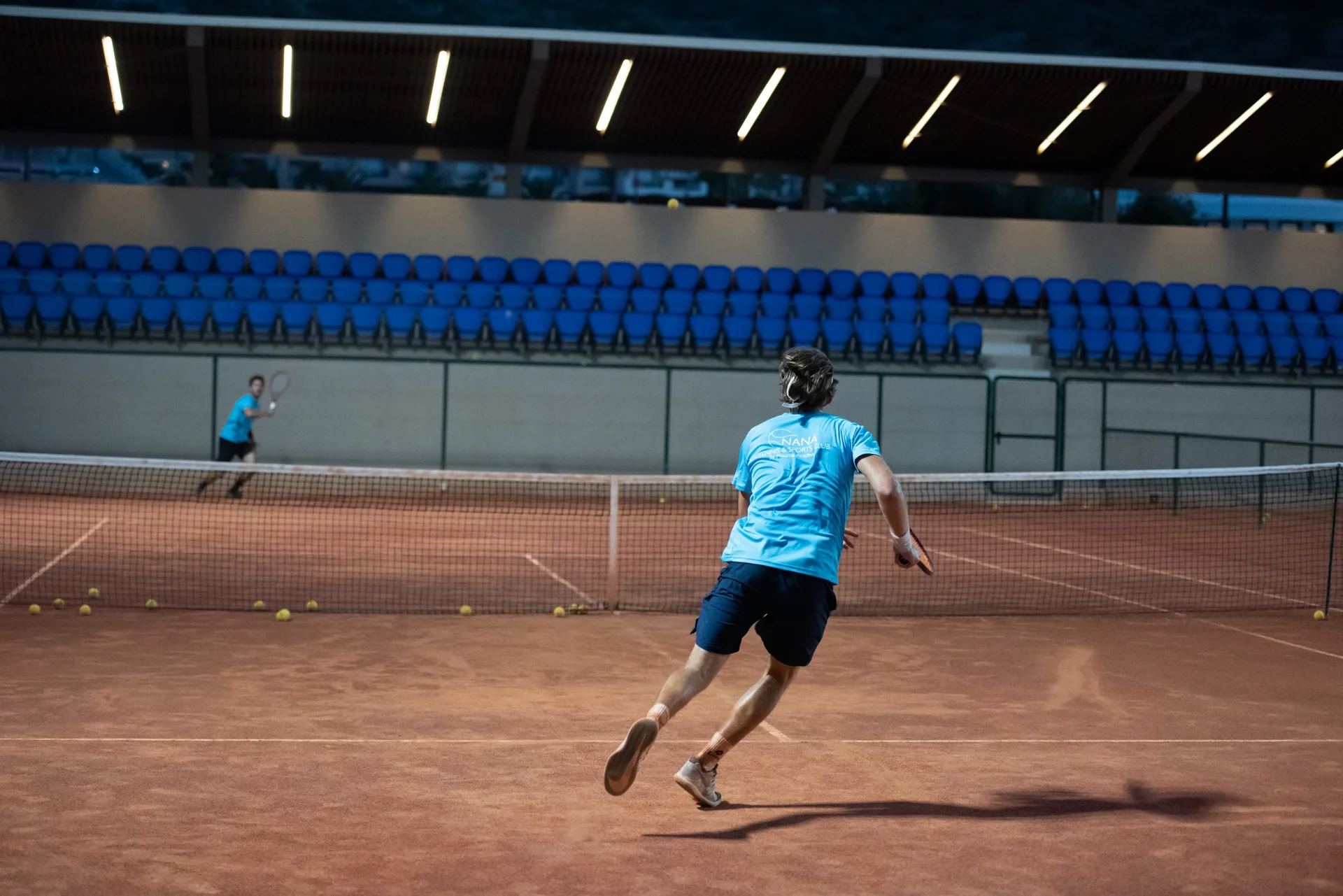 Tennis training on an indoor clay court